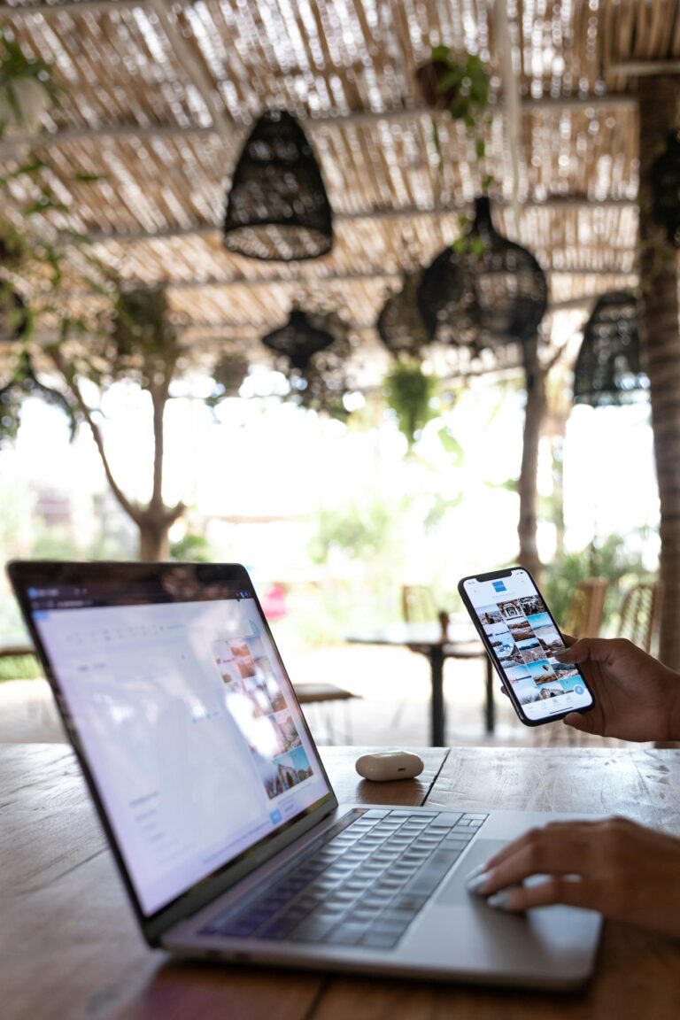 Person Using Laptop and Smartphone